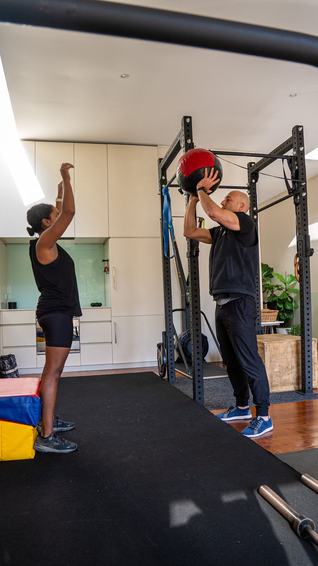 Ozgur coaching a client through a medicine ball drill at Biohacking Melbourne